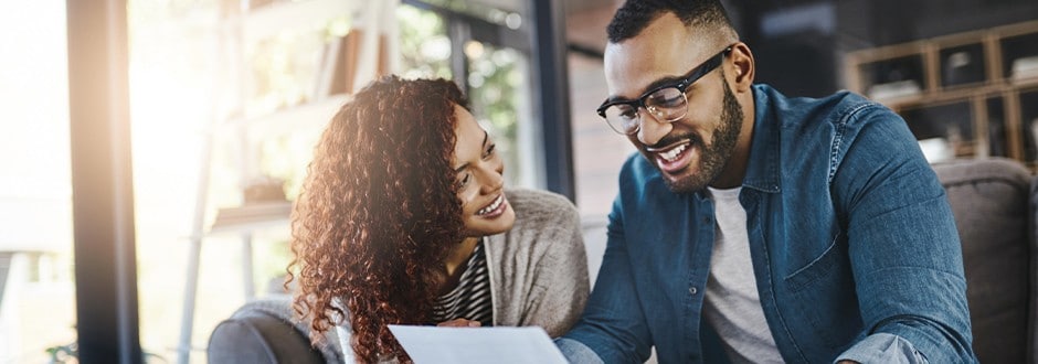 Young couple reading about the differences between a home equity loan vs HELOC