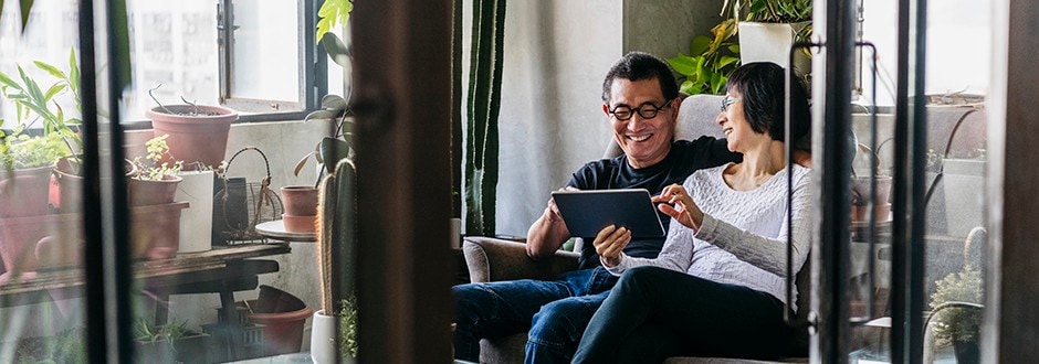 Couple in their living room reviewing home equity loan options that can help them pay off their debt