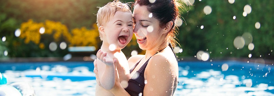 Mother and child in their beautiful swimming pool that they used a home improvement loan to help finance