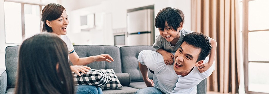 Family of four that accessed their home equity with a home equity loan enjoying their beautiful home.