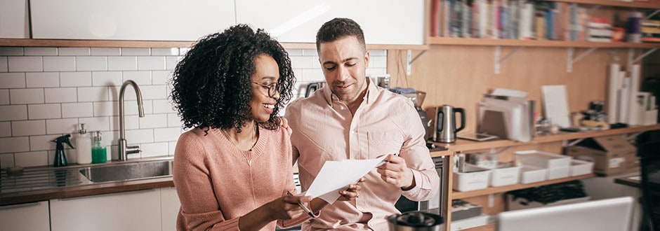 Couple researching how much home equity they have established as they use equity to purchase their second house