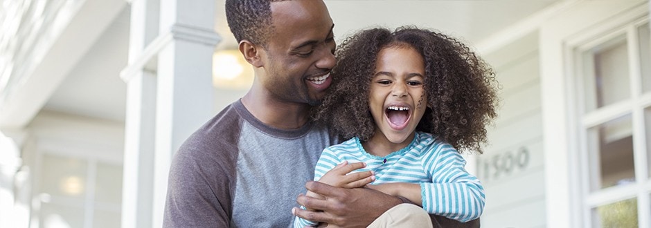Father and daughter smiling and laughing in their home that has increased it’s equity