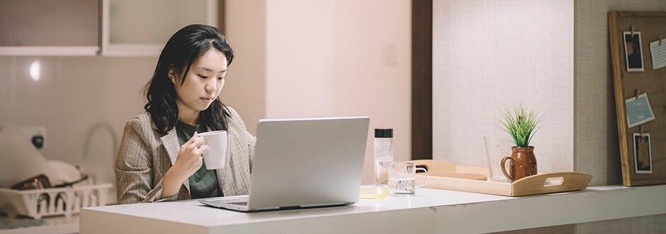 Woman on her laptop researching the best insurance option for her new home