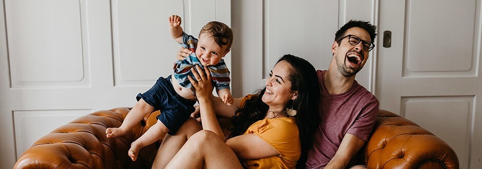 Young family laughing and having fun in their home