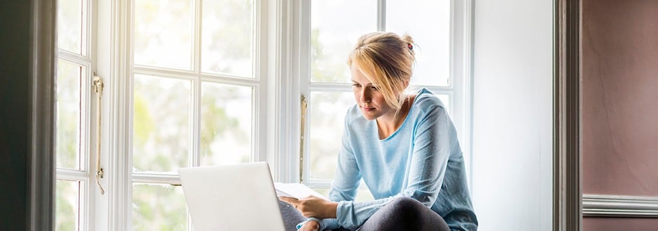 Woman researching is her home equity loan interest tax deductible in California on her laptop