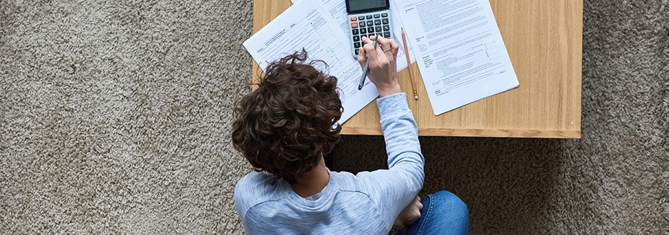 Man on couch calculating home equity loan LTV