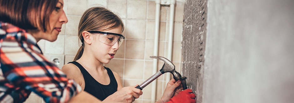 Mother and daughter removing tile during their master bathroom renovation home improvement project