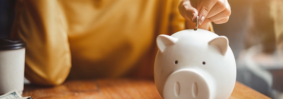 Piggy bank saving money for a down payment on a house