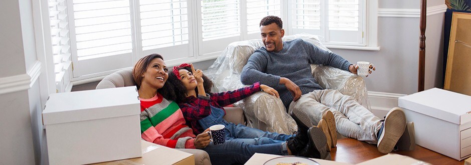 A family sitting together tallying their mortgage costs.