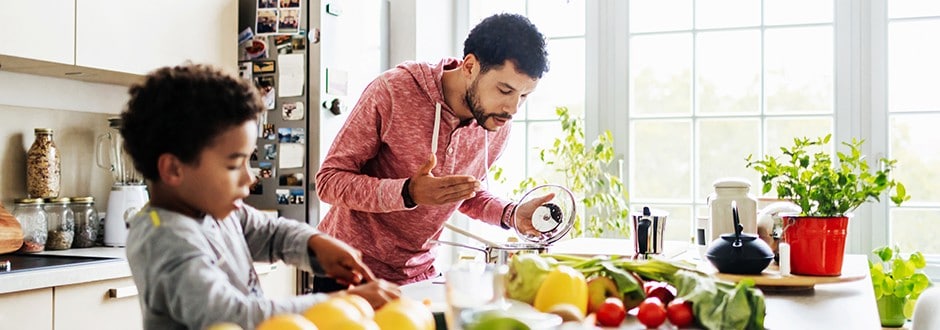 Father and son cooking in their newly remodeled low expense kitchen that they saved up for and completed on a budget.