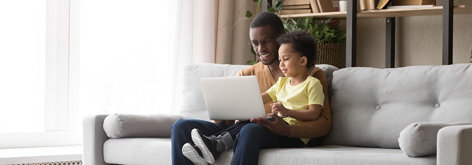 Young father with his son, calculating the costs and benefits of refinancing his home.