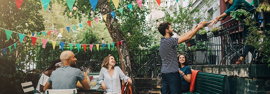 Family hosting a garden party after saving money on their mortgage refinance