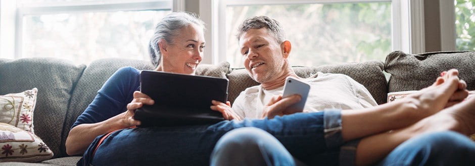 Couple sitting on their couch researching what is refinancing