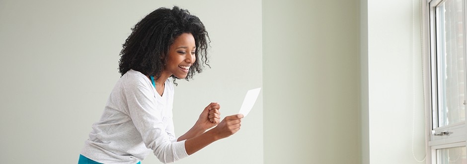 Woman deciding on if she wants to sell or lease her house now that she bought a new home