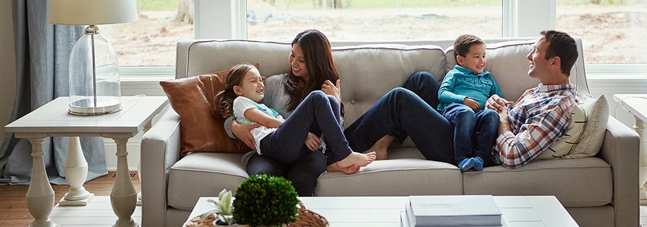 Family in living room of their new home that they researched extensively before purchasing