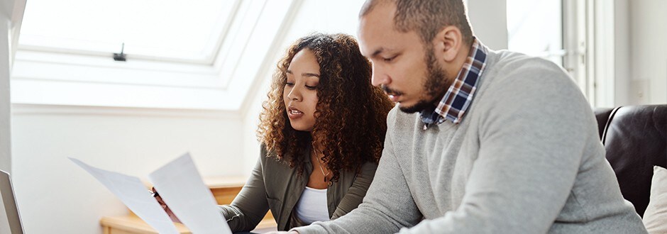 Couple looking at their credit score as they try to secure a HELOC approval