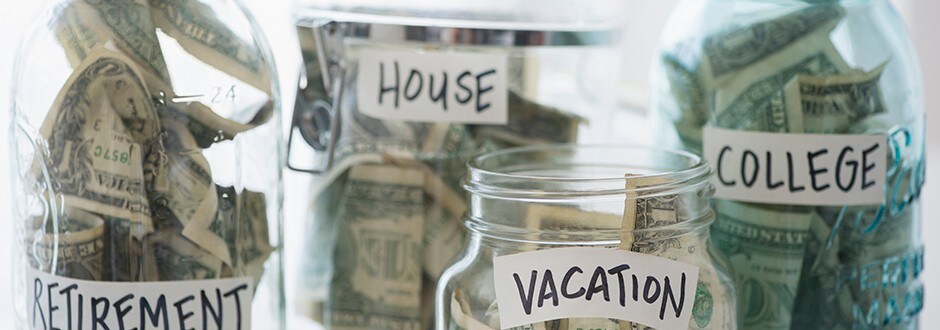 Close up of savings jars with money