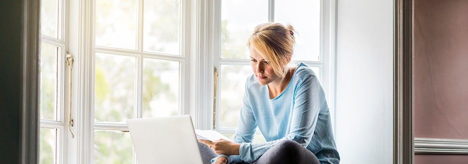 Woman evaluating her good faith estimate on her computer