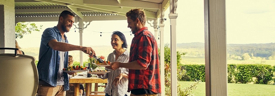 Young man that completed a backyard home improvement project enjoying it with his friends.