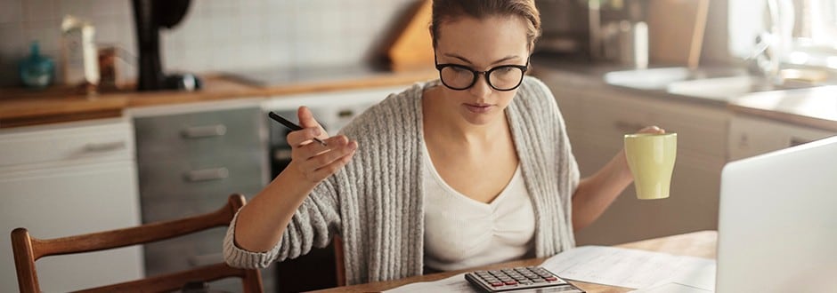 Woman drinks coffee while evaluating the different home equity lenders that she can choose based on their pros and cons