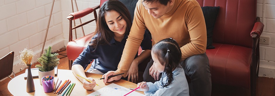 Man with his children coloring a picture in their new house that has a HOA