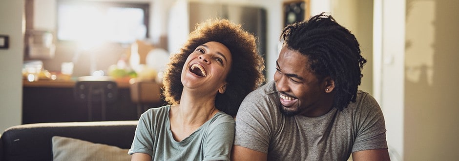 Couple laughing and joking while they discuss if it is time to stop renting and purchase a home