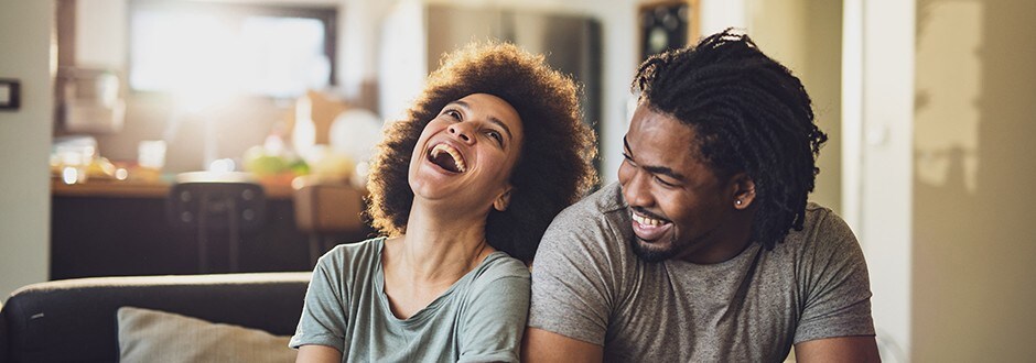 Couple laughing while they discuss the best home equity loans and what will work for them