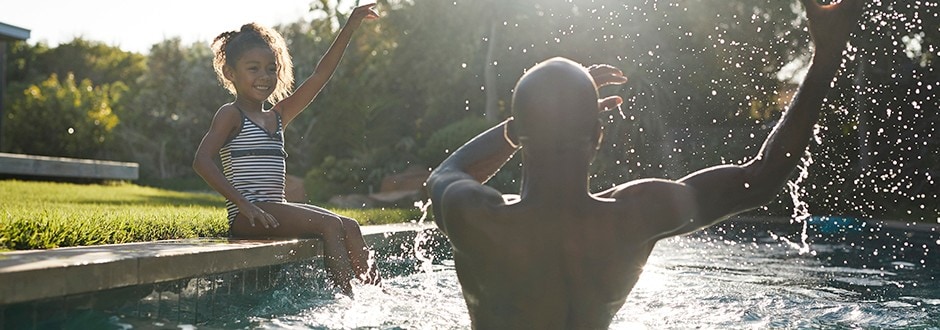 Father and daughter in the swimming pool of their second home.