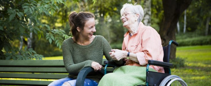 Woman and her elderly mother enjoying an afternoon at the park