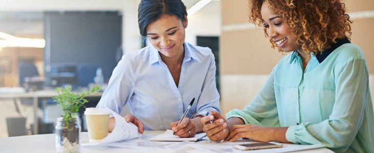 Two young women at a work meeting