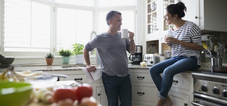 Husband and wife discussing their budget over coffee