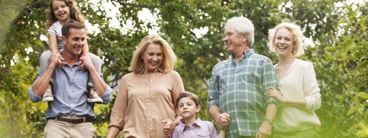 A family, with grandparents, takes a walk in the countryside.