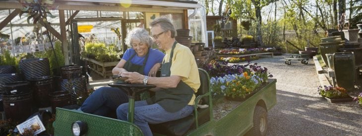 Older couple working in a garden nursery