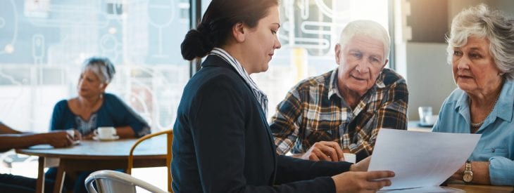 Retired couple meeting with a financial advisor to discuss withdrawal strategies