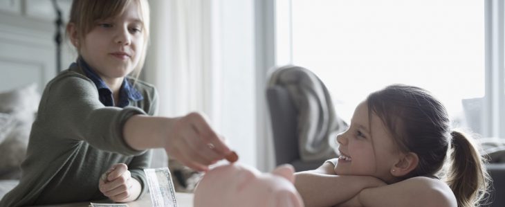 Young children learning the importance of saving money