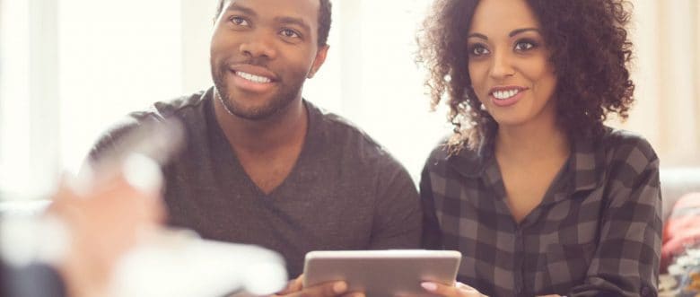 A young couple sits down and plans their retirement finances.