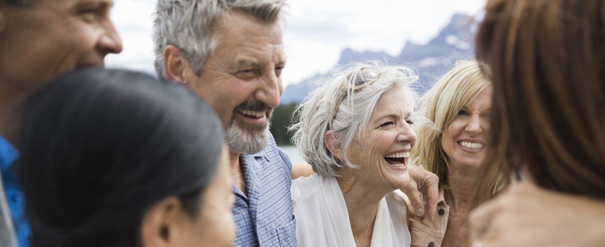 A group of friends, in their 50s or 60s, enjoys some time outdoors.