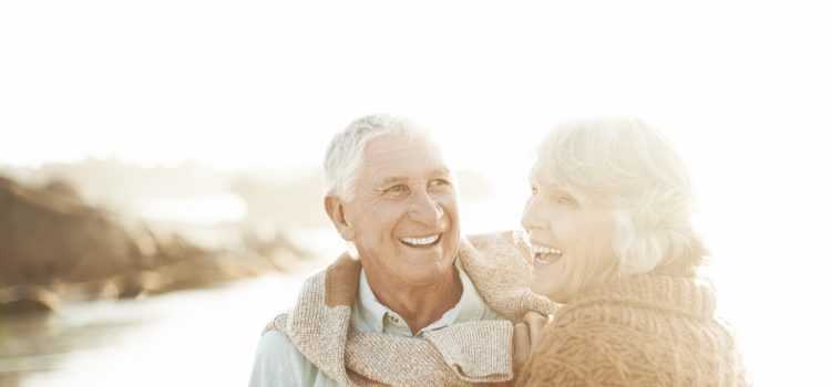 Retired couple enjoying sunset at the lake