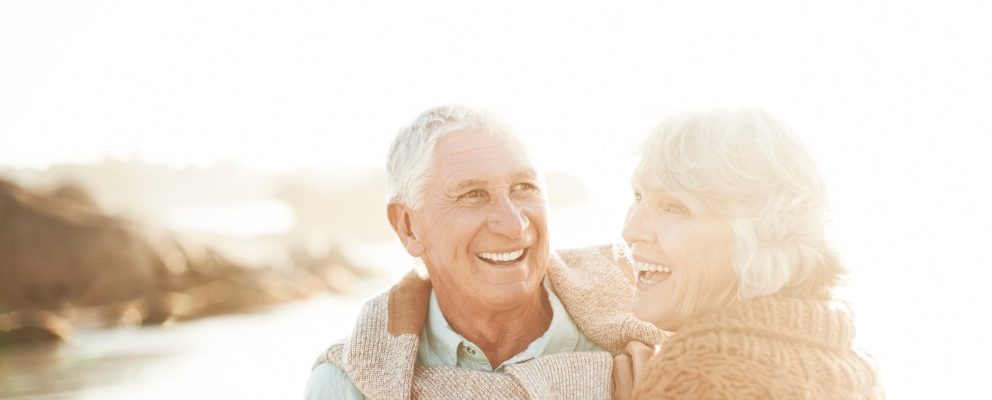 Retired couple enjoying sunset at the lake