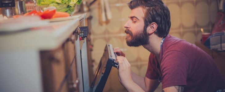 Man cooking dinner at home to save money