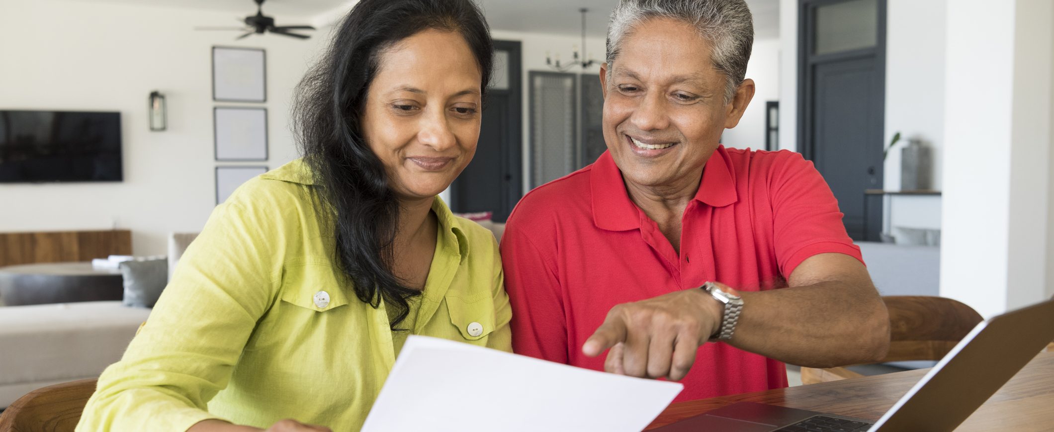 Middle-aged couple looking at their employer-sponsored retirement plans