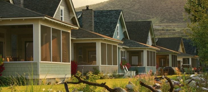 A row of houses, all with screened-in front porches.