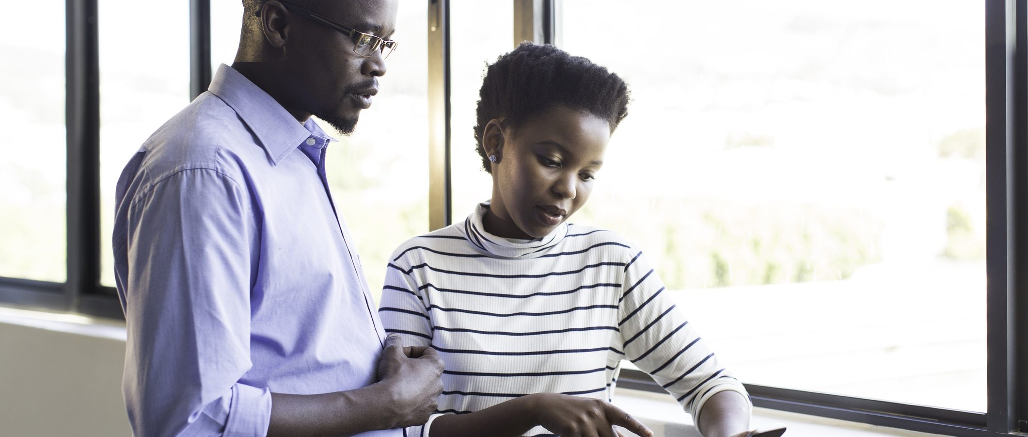 A man and a woman review their financial resolutions.