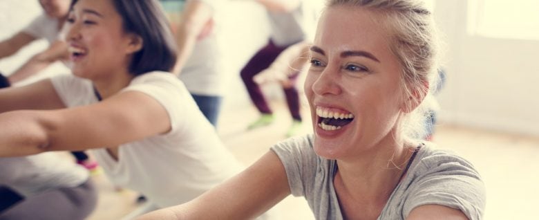 Closeup of women participating in a group exercise at a fitness center.