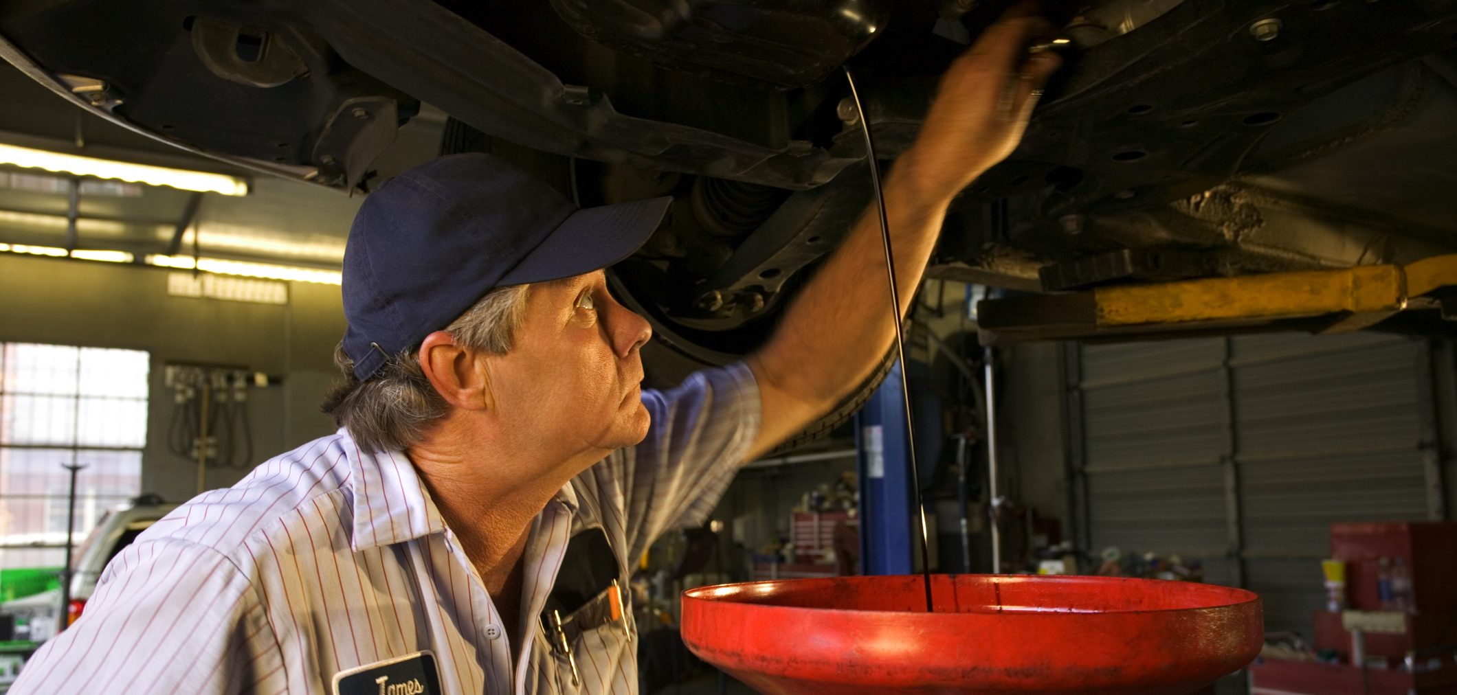  A mechanic performs and oil change.