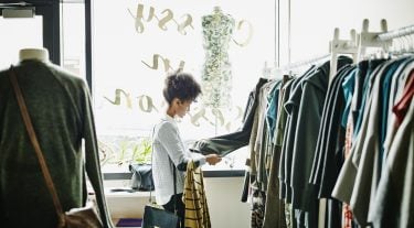 A woman shopping for clothes focuses on quality over quantity