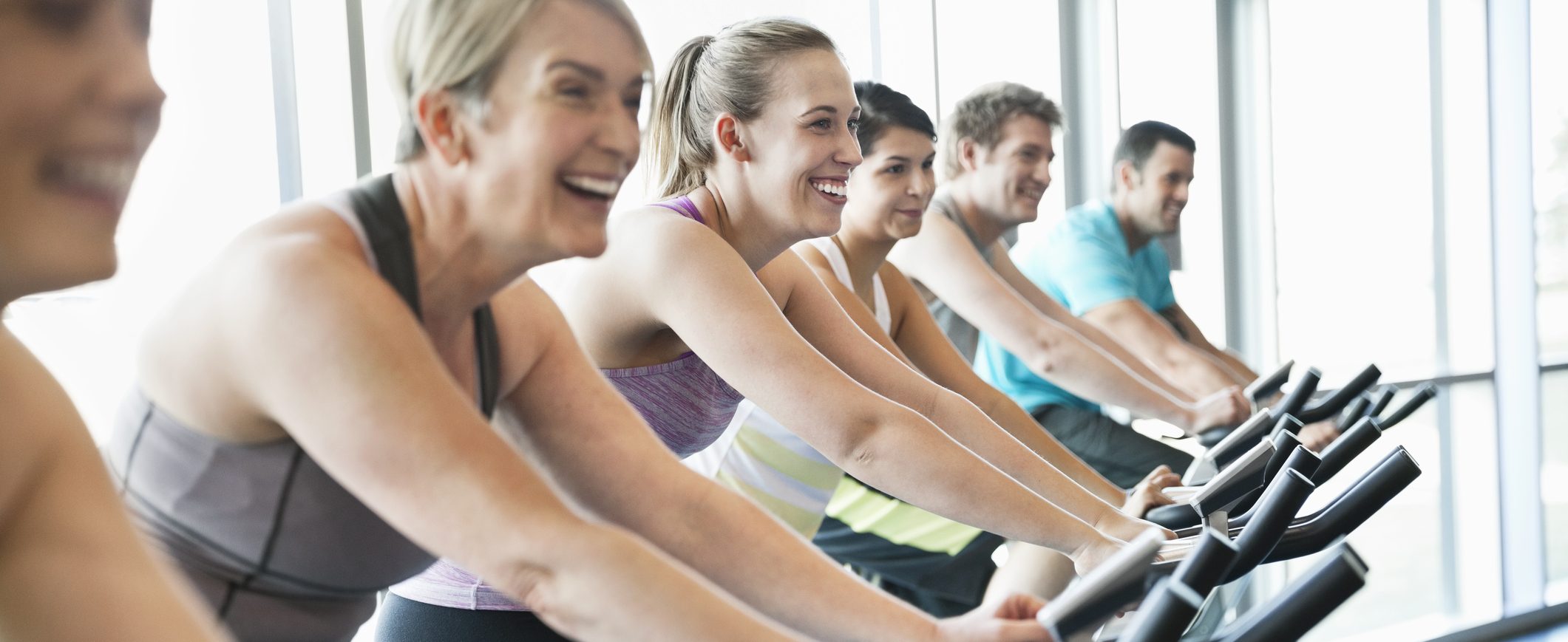 People on exercise bikes during a trainer-led spin class.