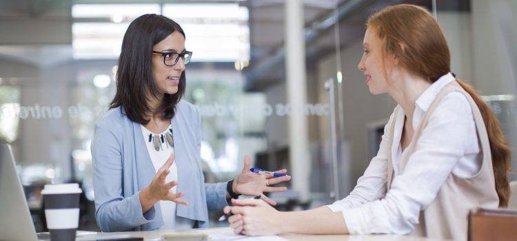 Woman meets with her boss to negotiate a higher starting salary