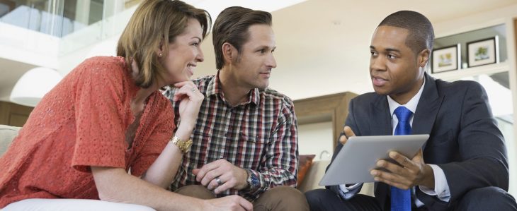 A financial planner showing options to a couple.