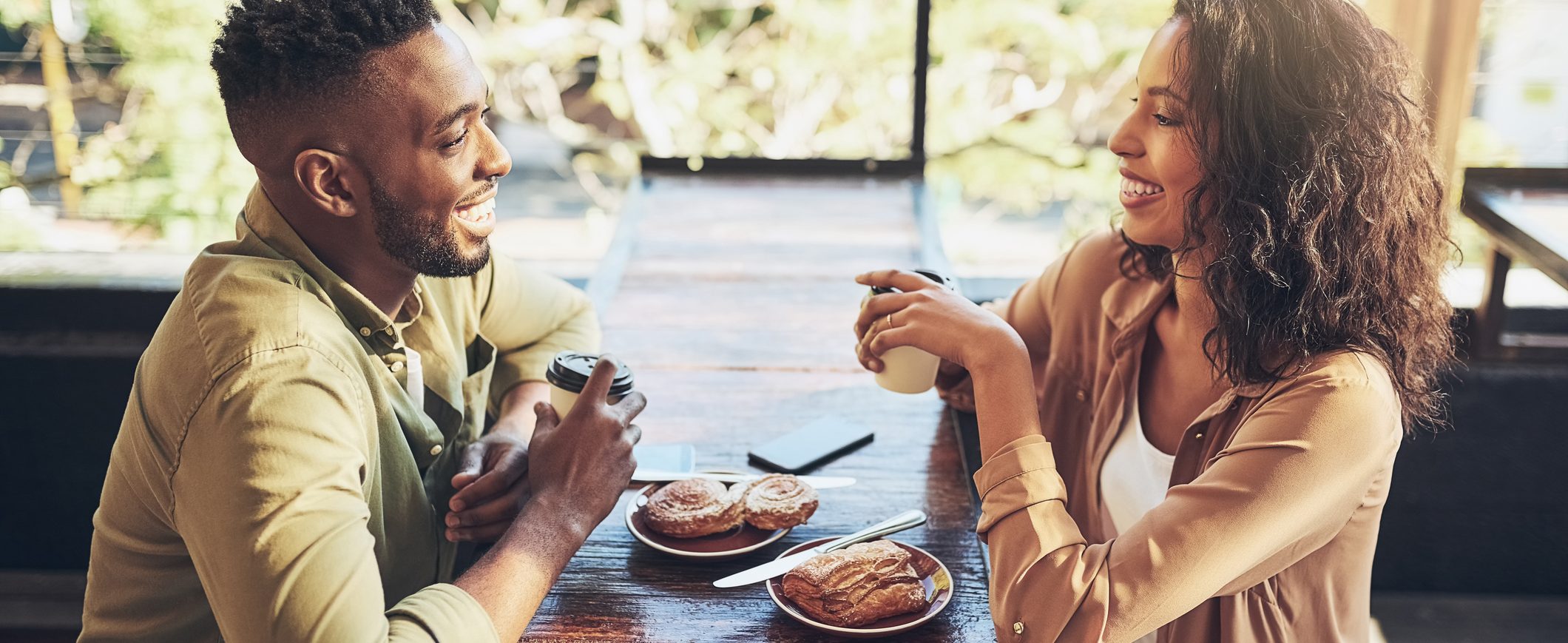 A man and a woman enjoy breakfast together at a coffee shop.